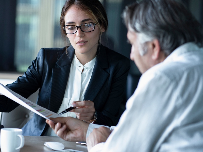 Woman Showing Man a Document